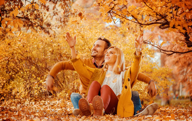 Happy young couple in autumn park