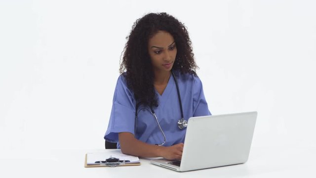 African American nurse using laptop