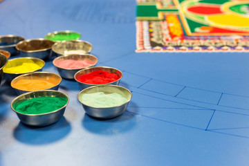 Metal cup with colorful sand for drawing mandala