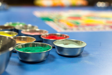 Metal cup with colorful sand for drawing mandala