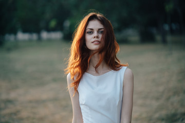 
woman in a white dress park

