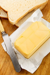 irish butter with fresh sliced bread on a wooden board