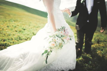 Pretty good wedding bouquet of various flowers in hand