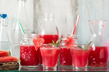Watermelon drink in glasses with slices of watermelon mint and lemon,