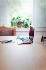 Office workplace with laptop and smart phone on wood table