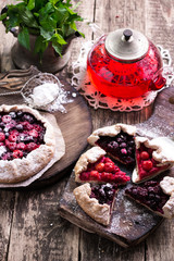 Blueberry,cherry,raspberry and blackcurrant galette on w wooden background.