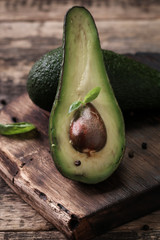 food background with fresh organic avocado on old wooden table, top view, copy space