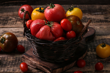 Colorful tomatoes, red tomatoes, yellow tomatoes, orange tomatoes, green tomatoes. Tomatoes background. vintage wooden background