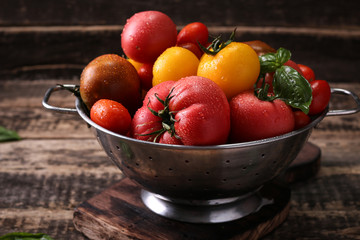 Colorful tomatoes, red tomatoes, yellow tomatoes, orange tomatoes, green tomatoes. Tomatoes background. vintage wooden background