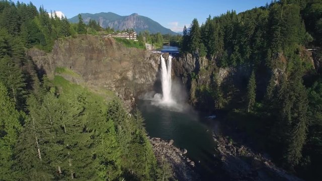 Helicopter View of Snoqualmie Falls Washington on Sunny Day with Mount Si in Distance