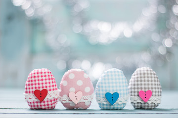 easter concept with colorful handmade eggs and rabbit on wooden table