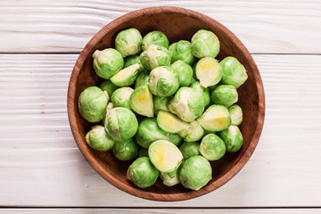 Fresh brussel sprouts over rustic wooden texture.healthy food