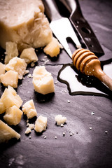 Composition of cheese, berries, bottles and glasses of wine on a wooden table