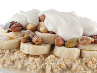 Fototapeta na wymiar oat flakes in soy milk with banana, nuts and lupin yogurt