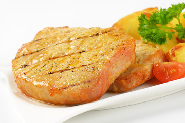 Grilled pork chops with potato wedges