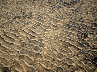 closeup of sand pattern of a beach in the summer