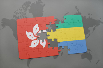 puzzle with the national flag of hong kong and gabon on a world map background.