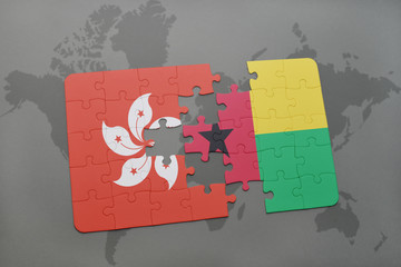 puzzle with the national flag of hong kong and guinea bissau on a world map background.