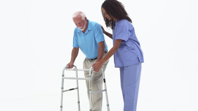 Nurse helping elderly patient with walker
