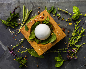 Herbs and spices in a mortar on the stone table.