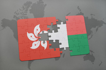 puzzle with the national flag of hong kong and madagascar on a world map background.