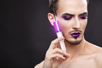 Fototapeta premium Pretty sensual gay man with art makeup and beard.