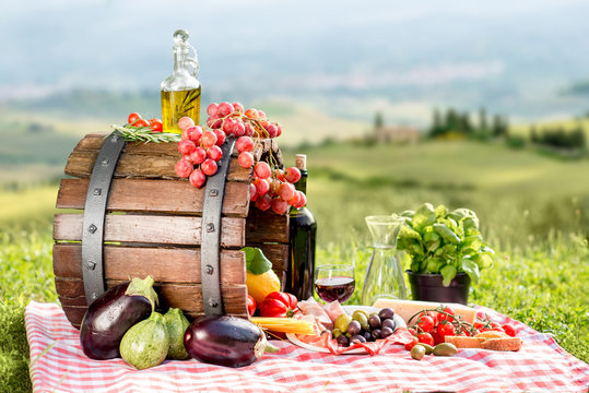 Lots Of Tasty Italian Food On The Napkin And Wooden Barrel Outdoors On The Tuscany Landscape Background