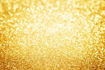 Gold background, golden bokeh from glitter for xmas, new year and holiday background, abstract