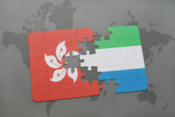 puzzle with the national flag of hong kong and sierra leone on a world map background.