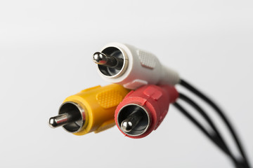 Several cables with RCA connectors for audio and video on white background