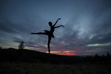 Ballet dancer posing during the sunset