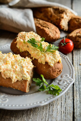 Whole wheat baguette with curd spread, eggs, carrot, green onion, pickled cucumber and mayonnaise