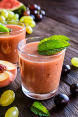 Organic smoothie with grape, watermelon and peach in a glass jar