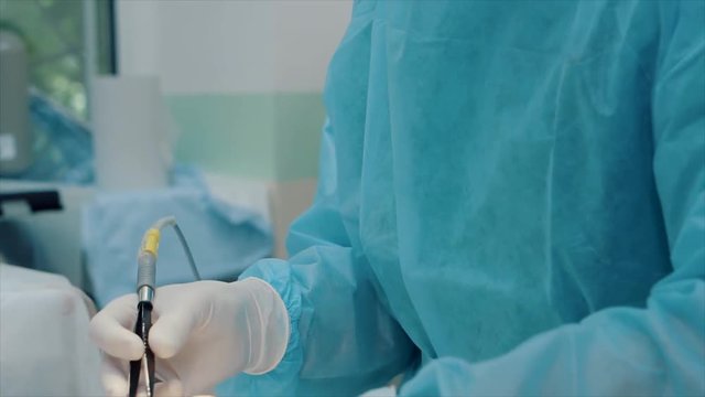 electrosurgery tool in surgeon's hand