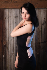 Fototapeta premium Girl standing in the doorway of an old village house