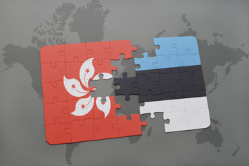 puzzle with the national flag of hong kong and estonia on a world map background.