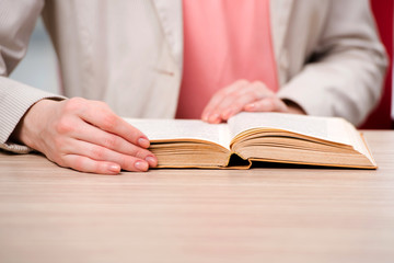 Young student reading book in preparation for exams