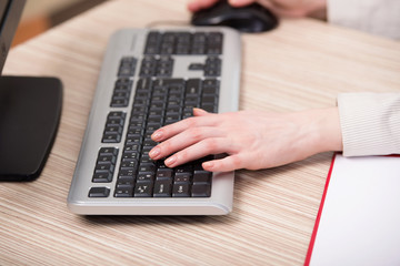 Hands working on the keyboard in the office