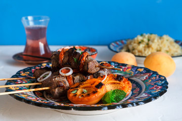Lamb kebab with dried apricot, bulgur and rose tea