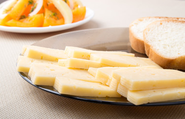 Slices of cheese and bread on a plate closeup