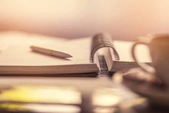 Blank notebook with pen on the office desk. Close up.