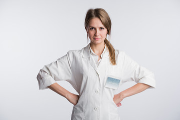 Portrait of Woman surgeon doctor in confident pose isolated over white background with hands on hips