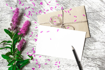 Blank white greeting card, envelope and pencil with purple wildflowers