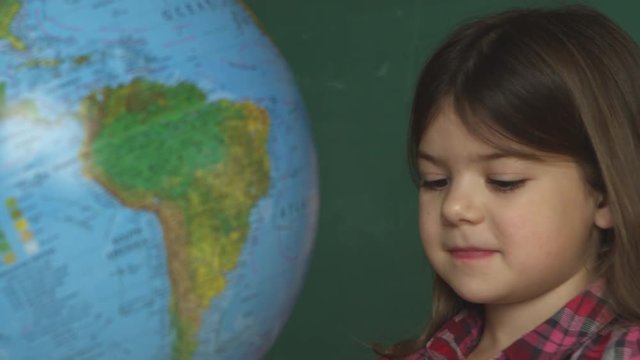 young girl learning about the globe