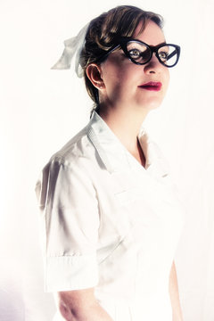Nurse Classic Vintage Glasses. Classic female nurse in authentic vintage uniform. Edited in a vintage film style.