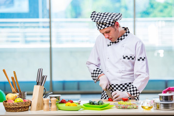 Male cook preparing food in the kitchen