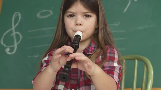 young girl playing recorder