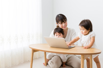 asian baby and mother using laptop in the room