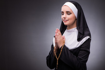 Religious nun in religion concept against dark background © Elnur