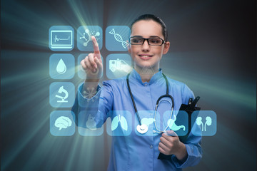 Woman doctor pressing buttons with various medical icons